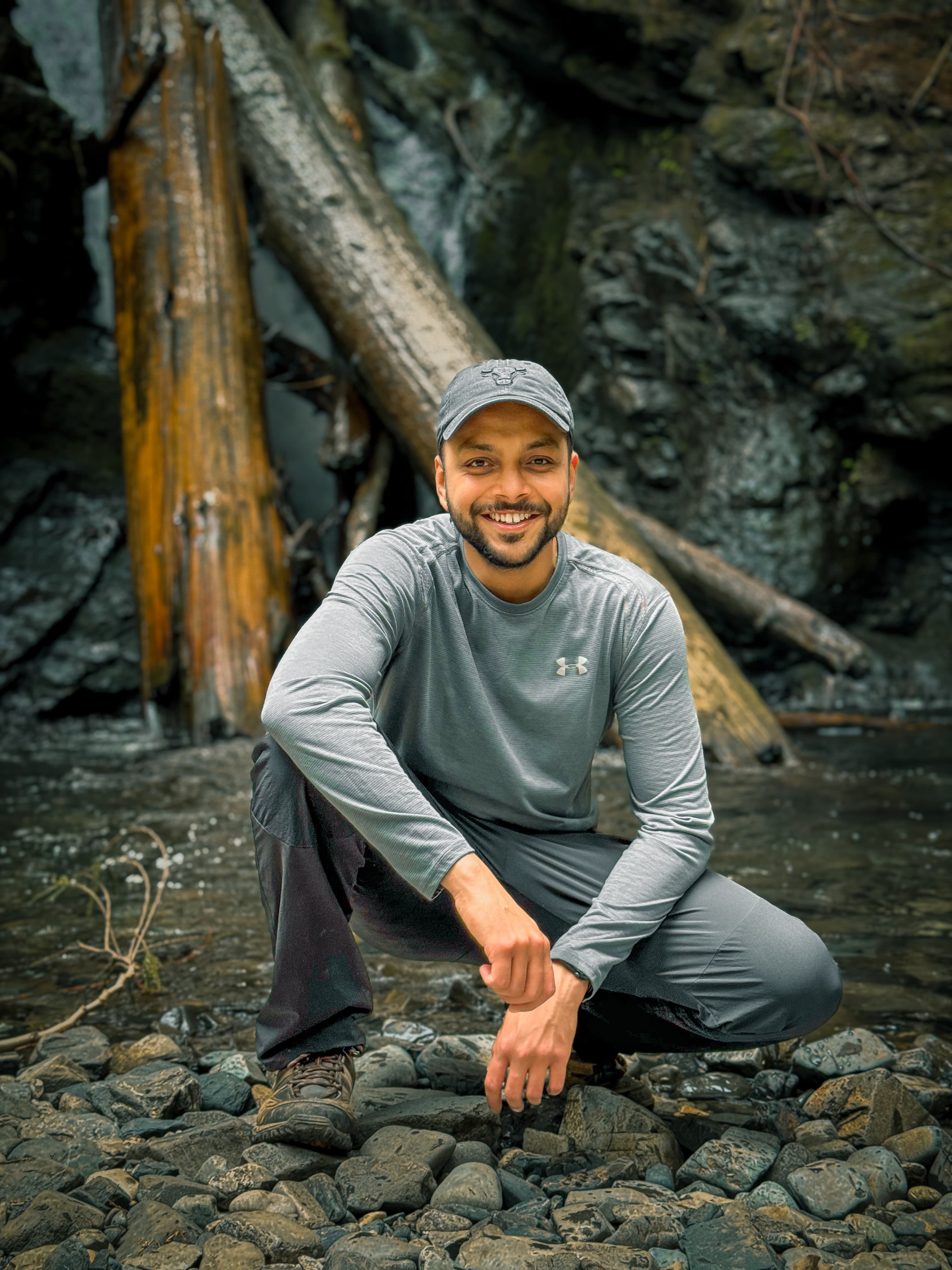 Portrait of Arjun at rocky waterfall in old-growth forest