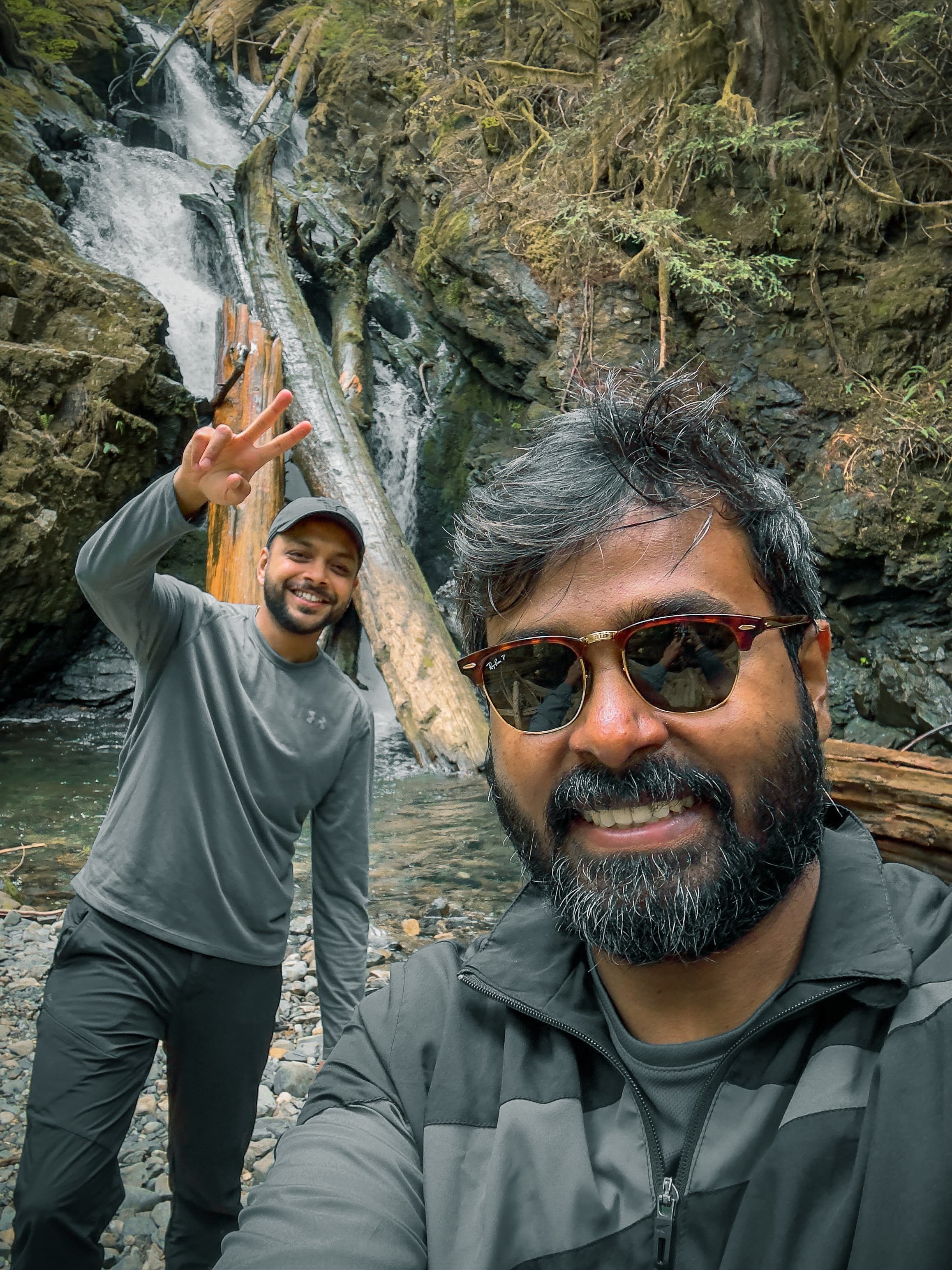 Pranoy and Arjun at a forest waterfall